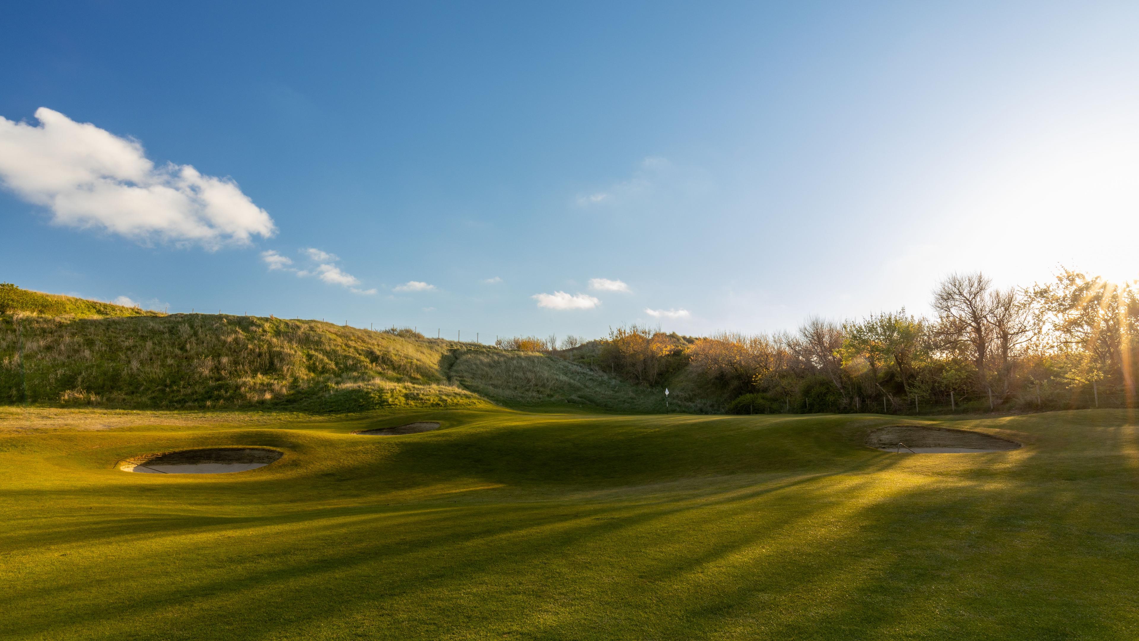 A well maintained fairway leading to a smooth green