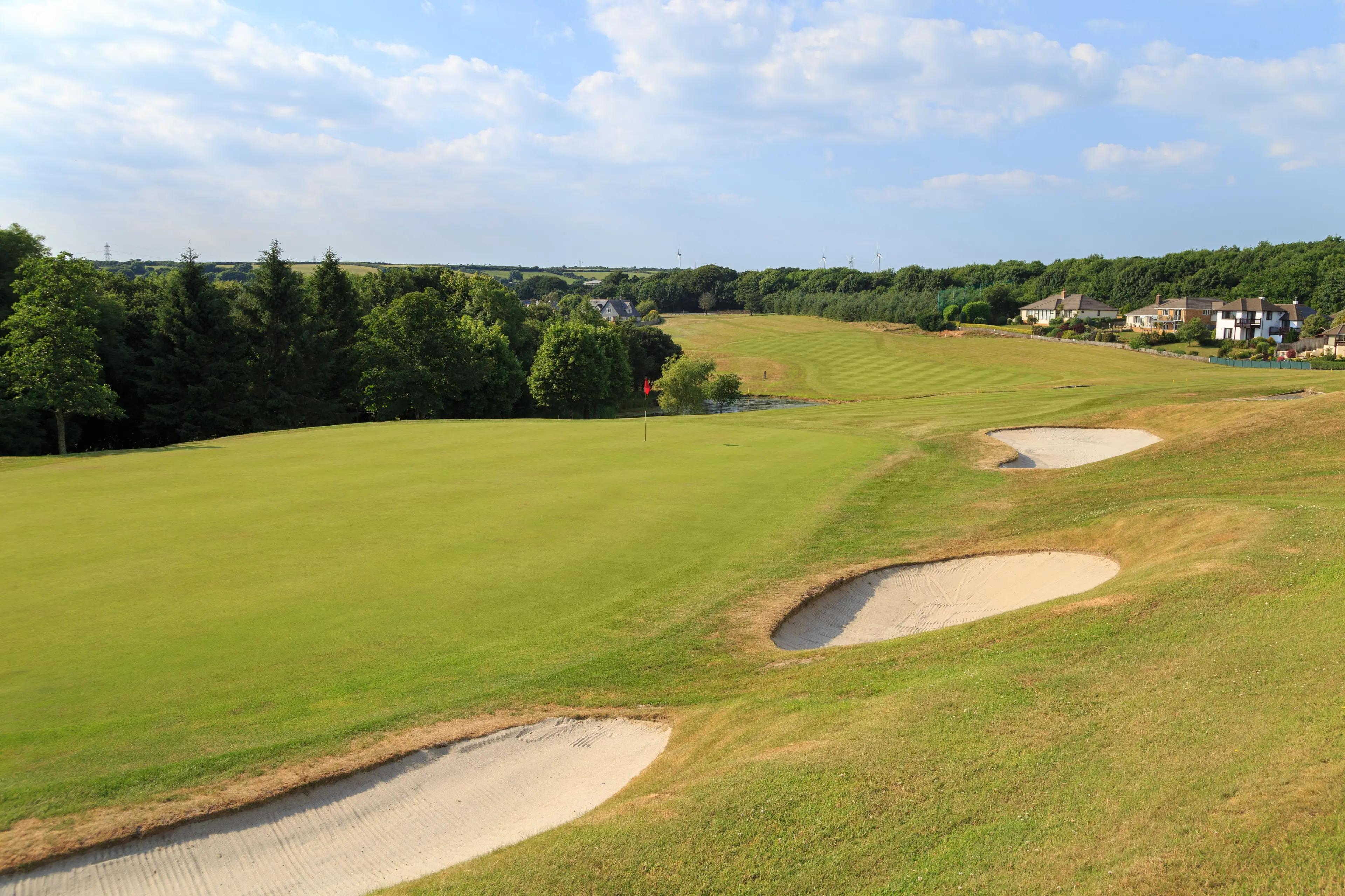 Panoramic view of a well maintained fairway nestled with sand bunkers
