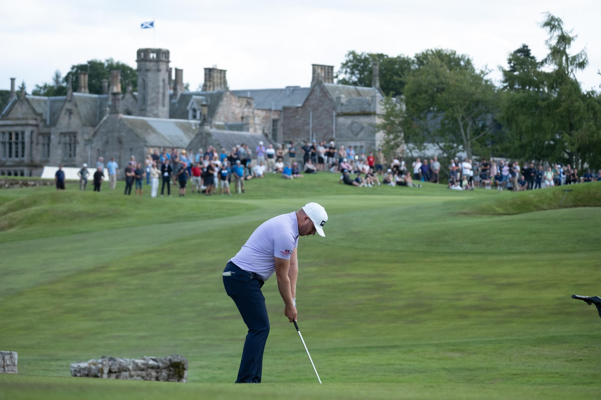 Golfer readying his swing on a well maintained fairway