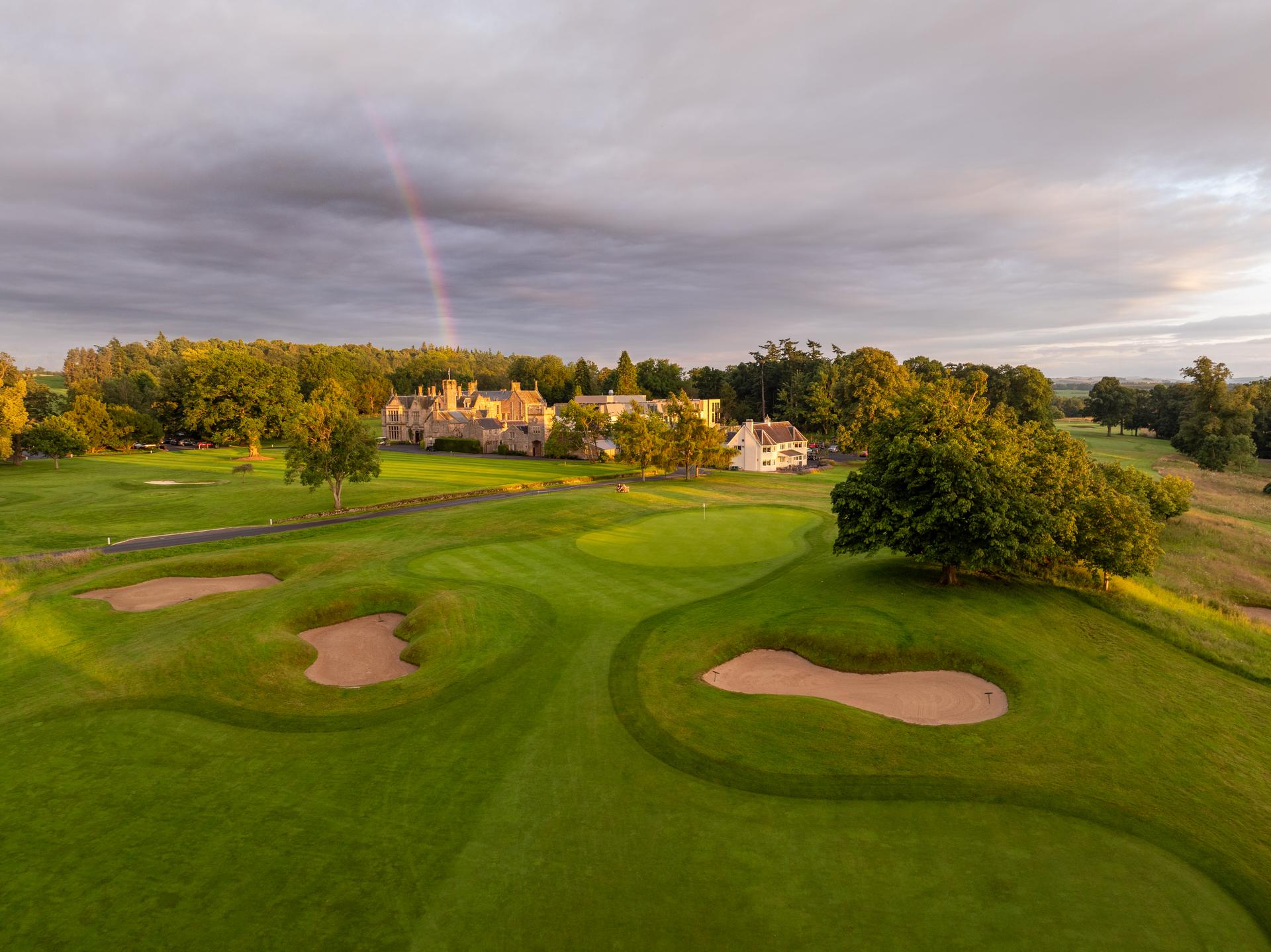 A well maintained fairway nestled with sand bunkers