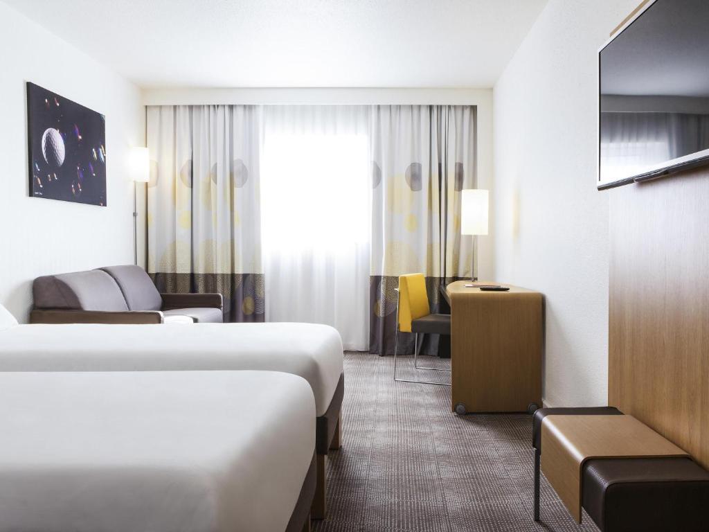 Twin bed suite at Novotel Saint Quentin en Yvelines