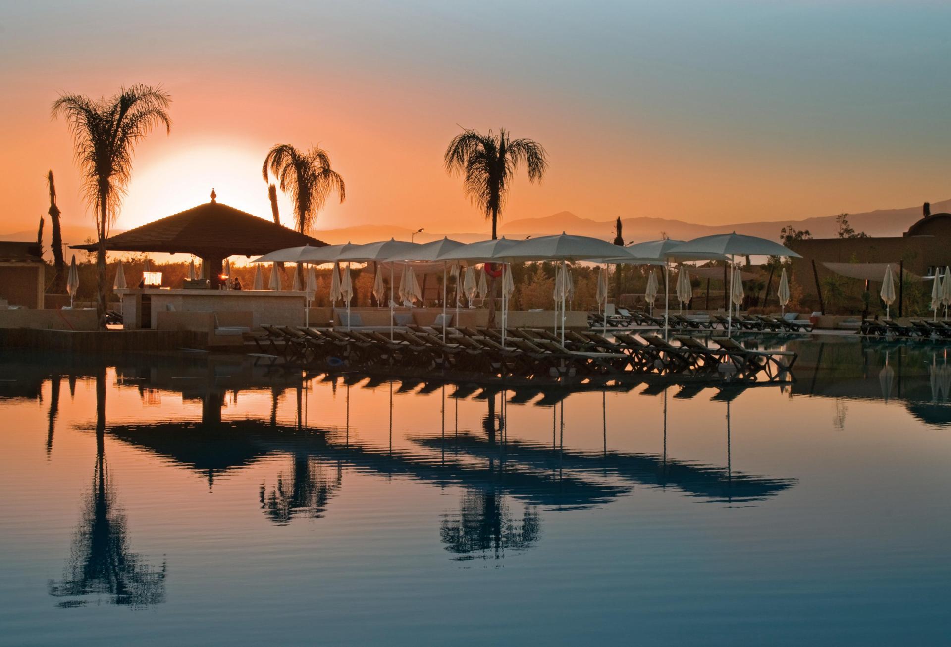 Sun setting over the outdoor pool at Clubhotel Riu Tikida Palmeraie