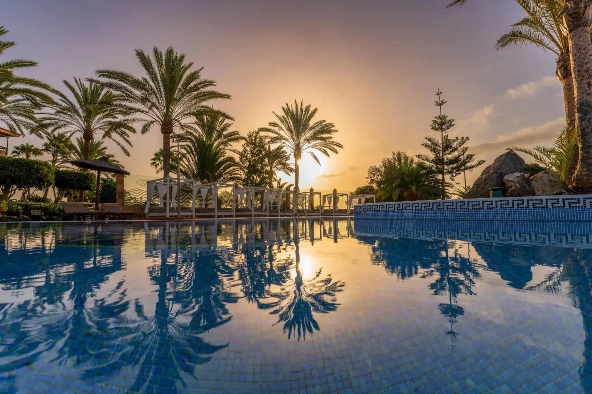 Sun shining over the outdoor swimming pool at Elba Palace Golf & Vital Hotel