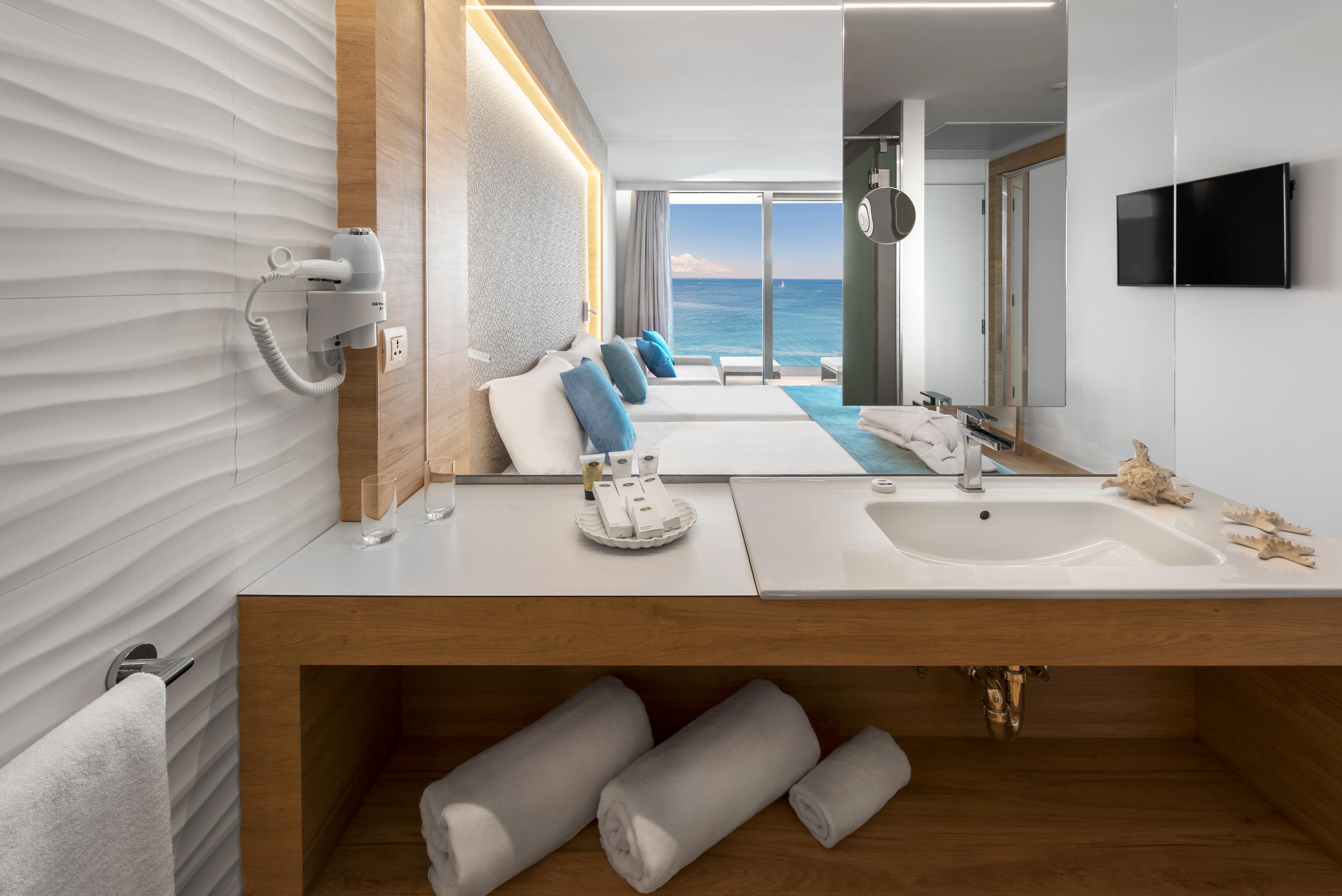 A twin bed suite with a bathroom and balcony views