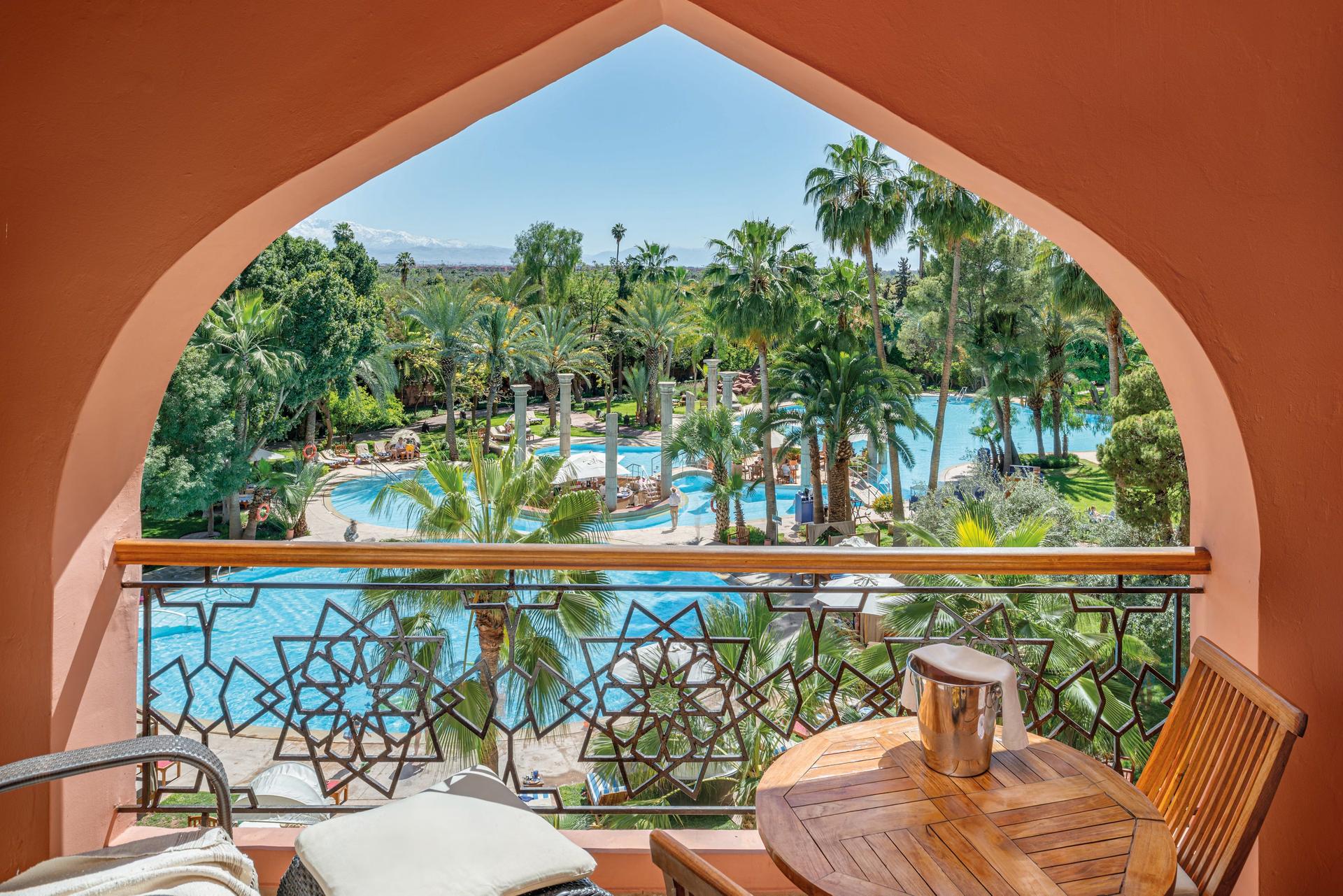 Balcony views of the outdoor pool at Es Saadi Marrakech Resort – Palace