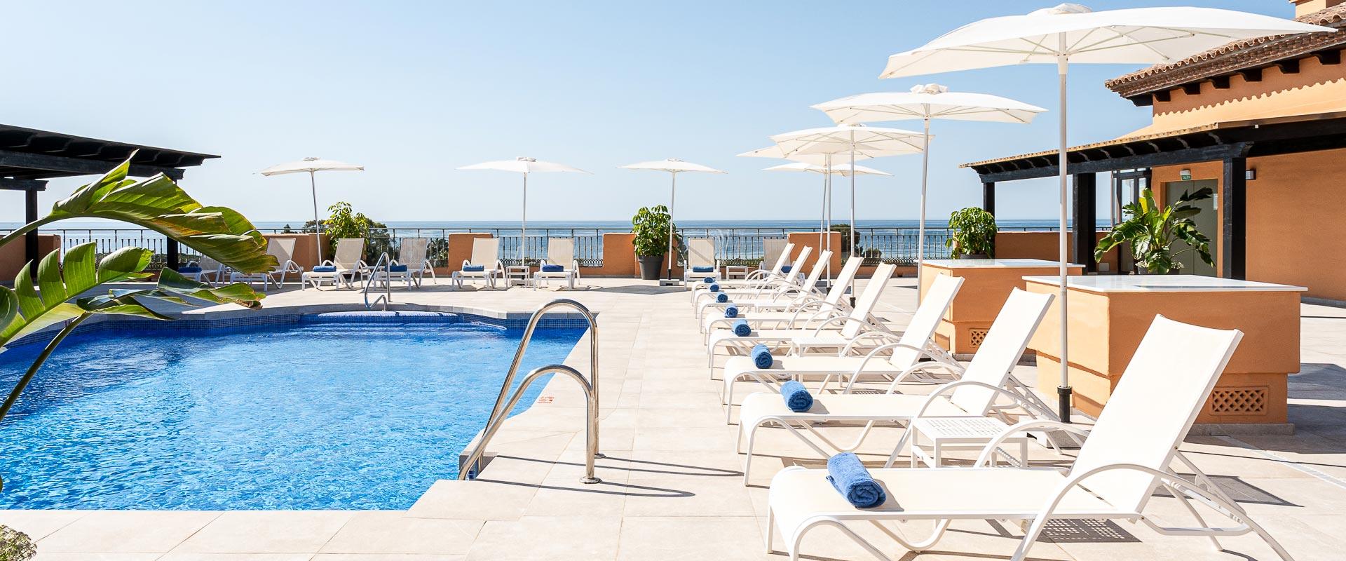 Outdoor pool lined wit sunbeds at Globales Paraiso Beach