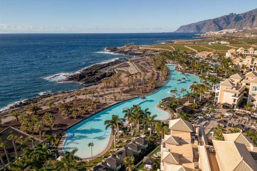 Overhead view of the outdoor swimming pool with sea views at Gran Meliá Palacio de Isora