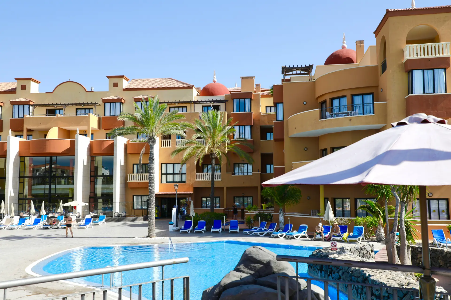 Panoramic view of the Grand Muthu Golf Plaza Hotel building overlooking the outdoor pool