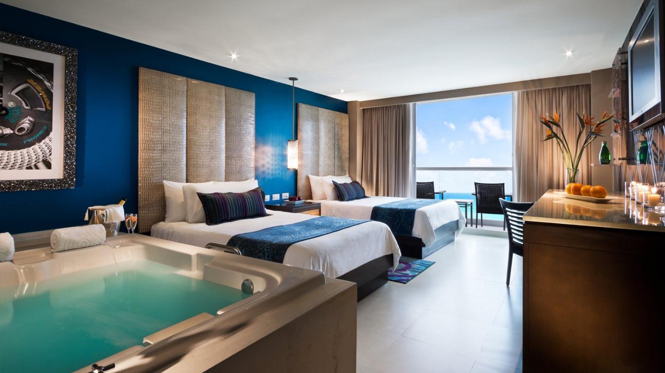 Twin bed suite with a jacuzzi and balcony views