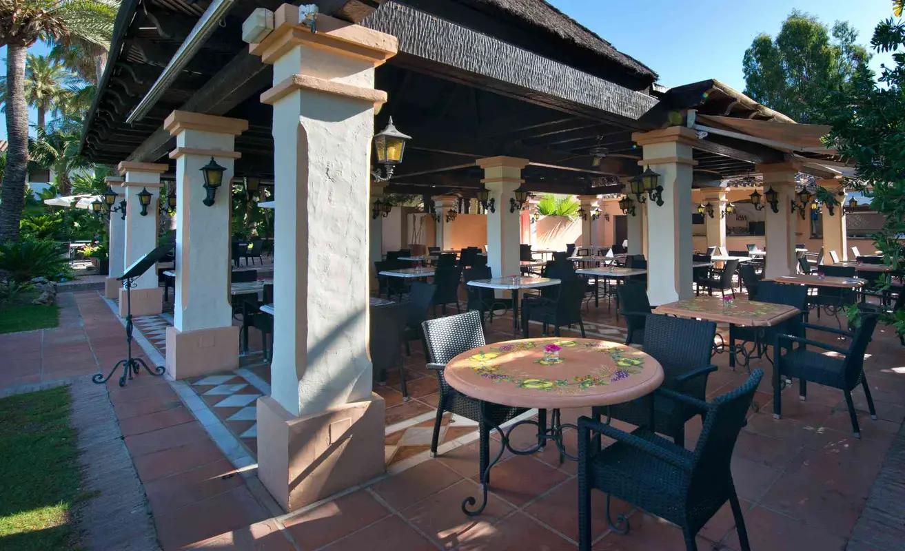 Outdoor lounging and dining area at Hotel BlueBay Banús