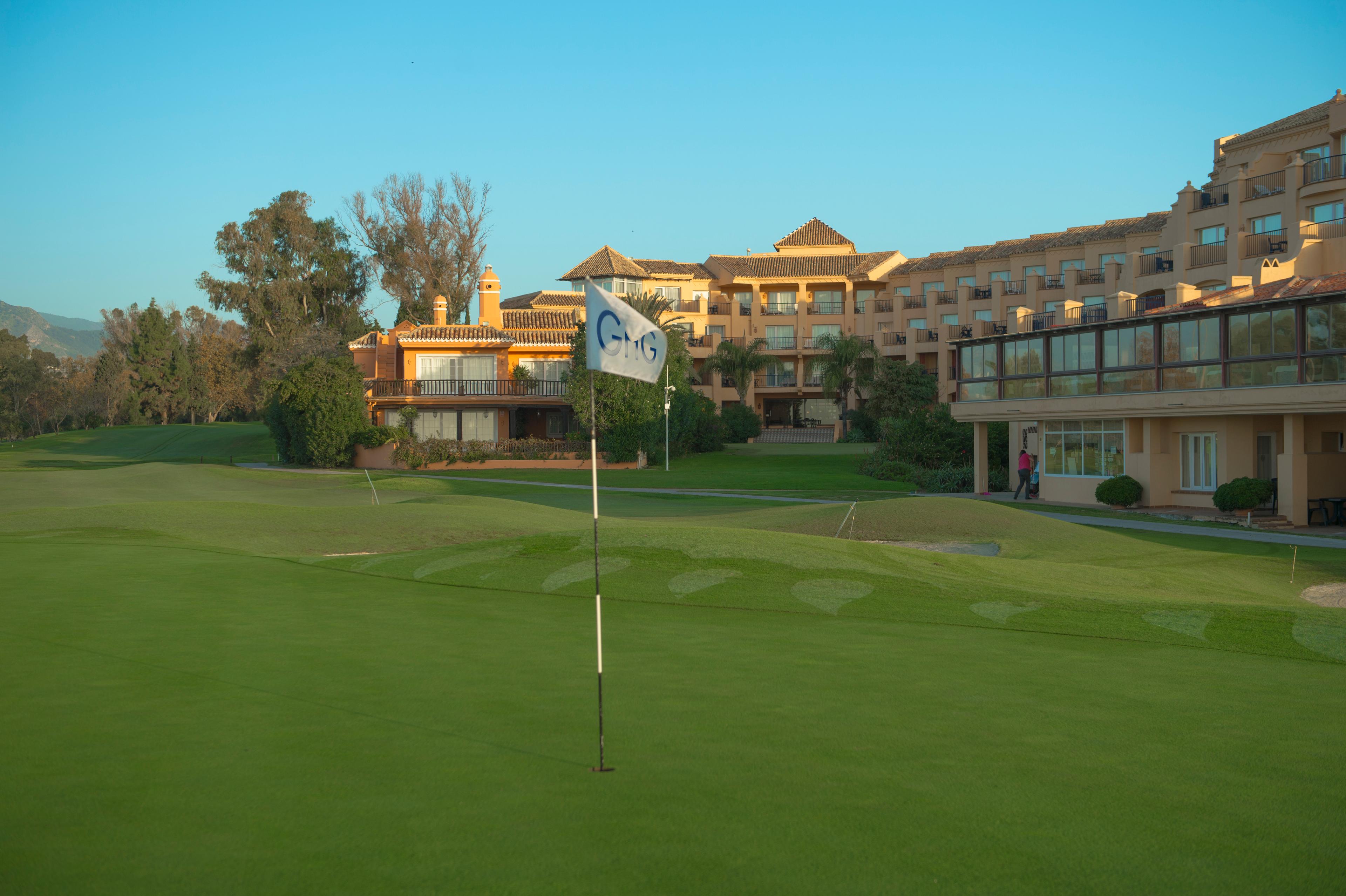 Panoramic view of Hotel Guadalmina Spa and Golf Resort overlooking a smooth green