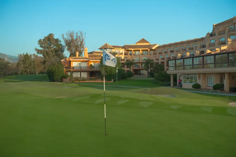 Panoramic view of Hotel Guadalmina Spa and Golf Resort overlooking a smooth green