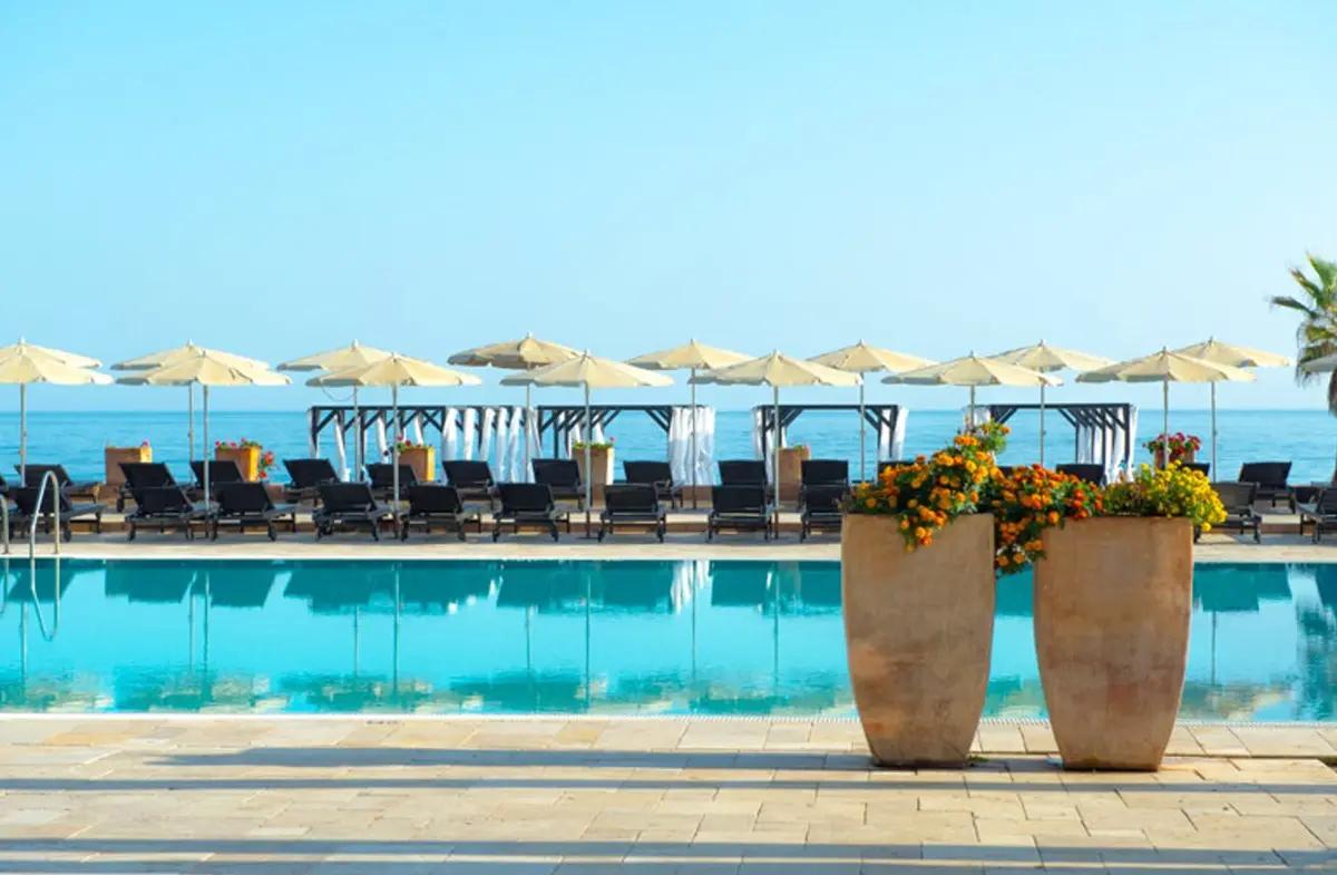 Outdoor swimming pool under clear blue skies at Hotel Guadalmina Spa and Golf Resort