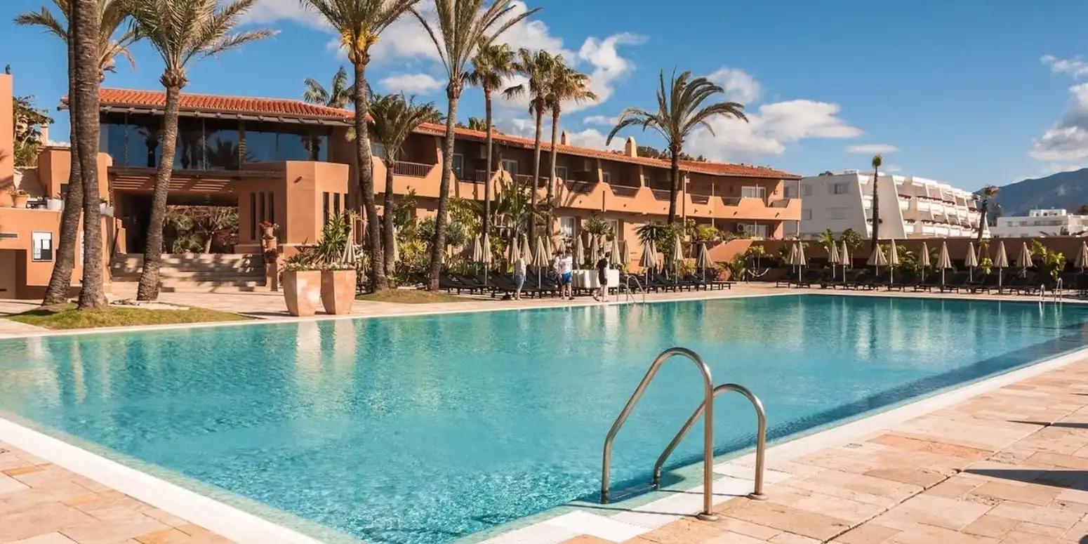 The Hotel Guadalmina Spa and Golf Resort building overlooking the outdoor swimming pool
