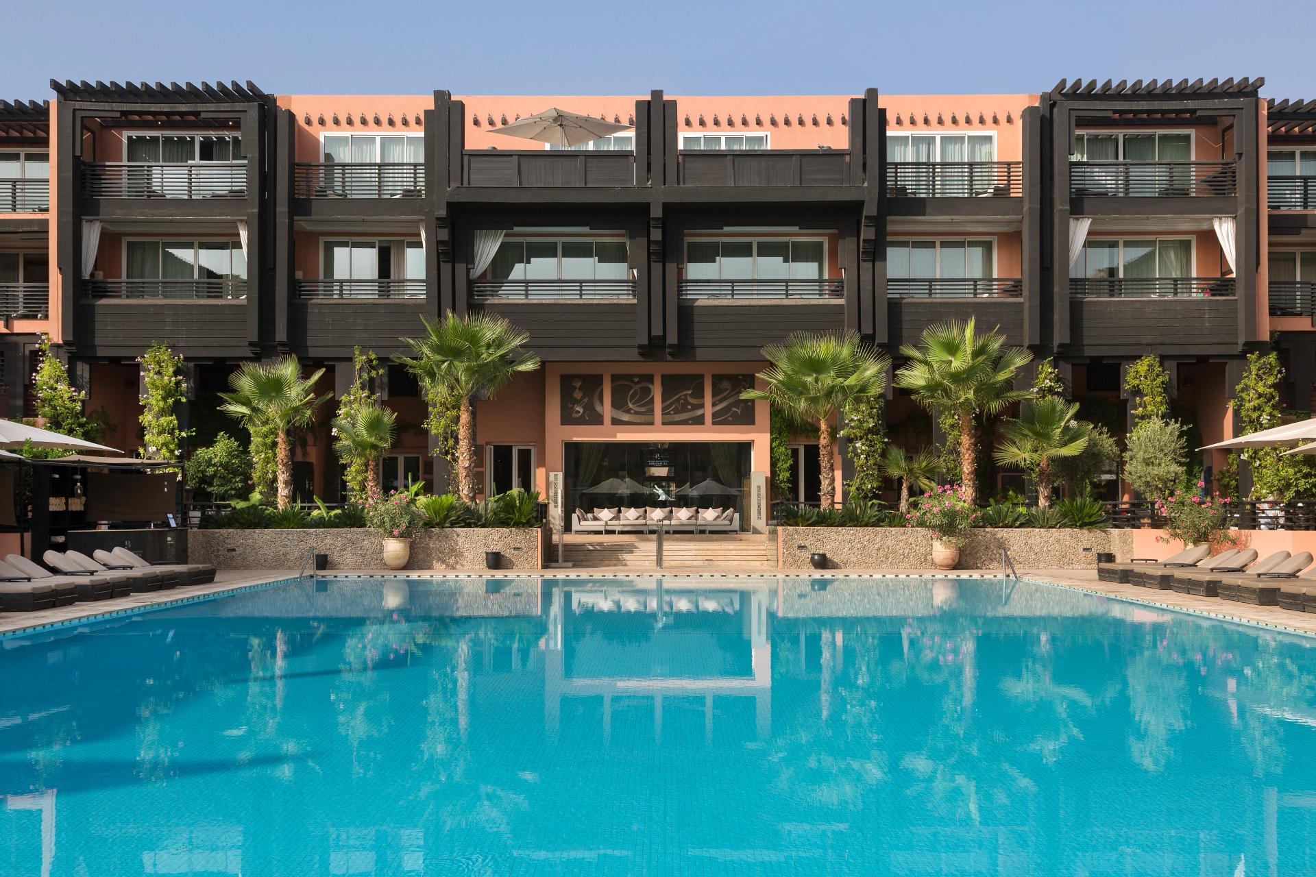 Panoramic view of the Hotel & Ryads Barrière Le Naoura building overlooking the outdoor pool