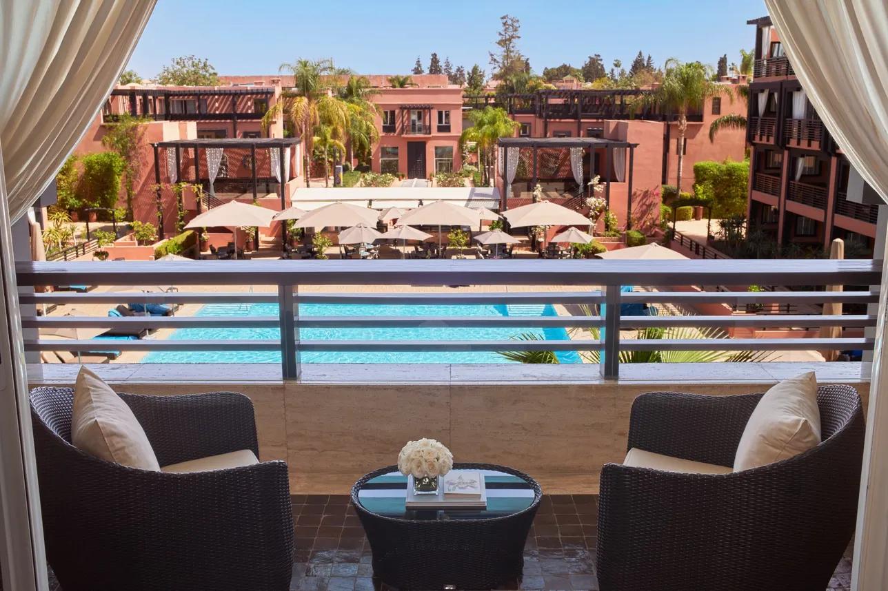 Balcony views of the outdoor pool at Hotel & Ryads Barrière Le Naoura