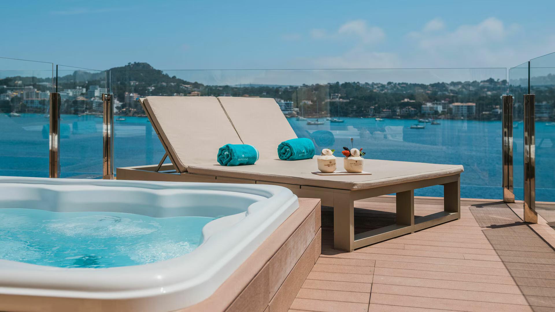 Balcony jacuzzi alongside sunbeds with views of the sea at Iberostar Jardín del Sol Suites