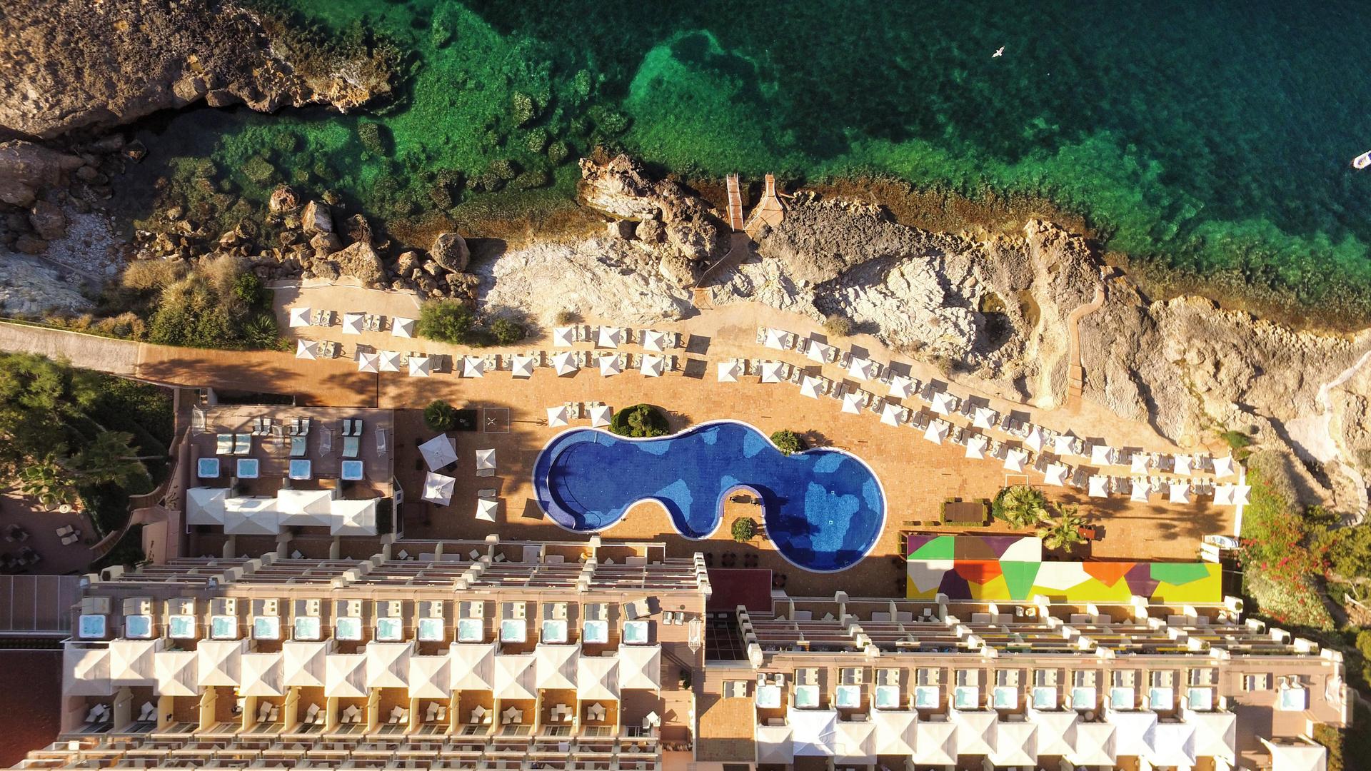 Aerial view looking down on the outdoor swimming pool at Iberostar Jardín del Sol Suites