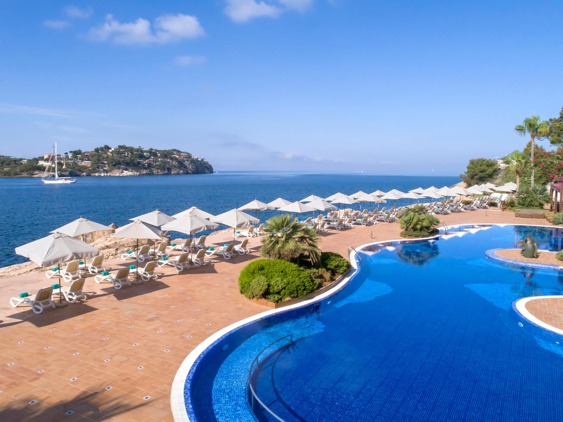Panoramic view of the outdoor pool with sea views at Iberostar Jardín del Sol Suites
