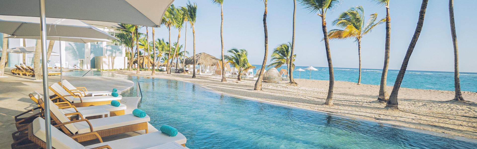 An outdoor swimming pool with beach views at Iberostar Selection Bávaro Suites