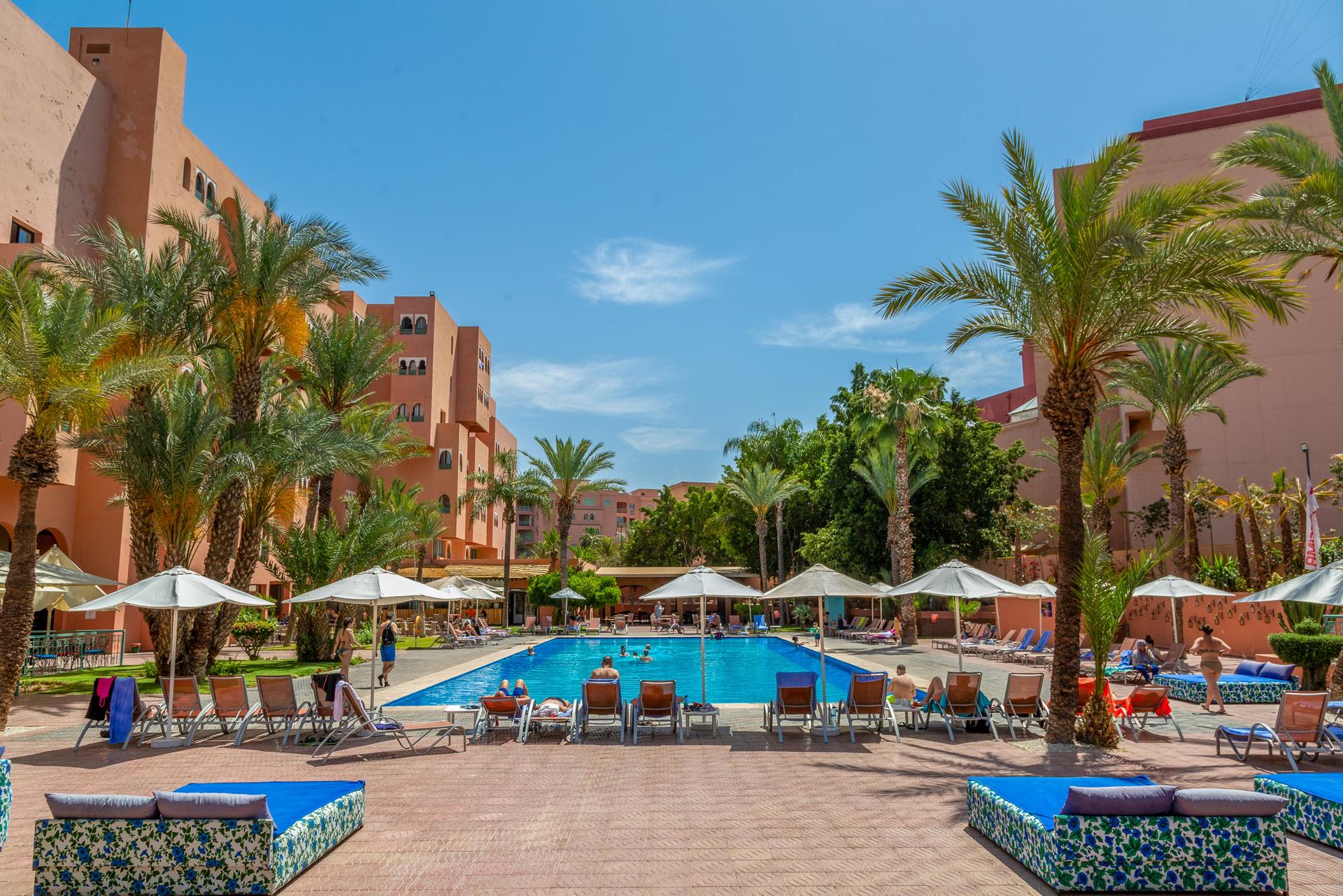 Outdoor swimming pool lined with sunbeds at Labranda Rose and Aqua Parc Hotel