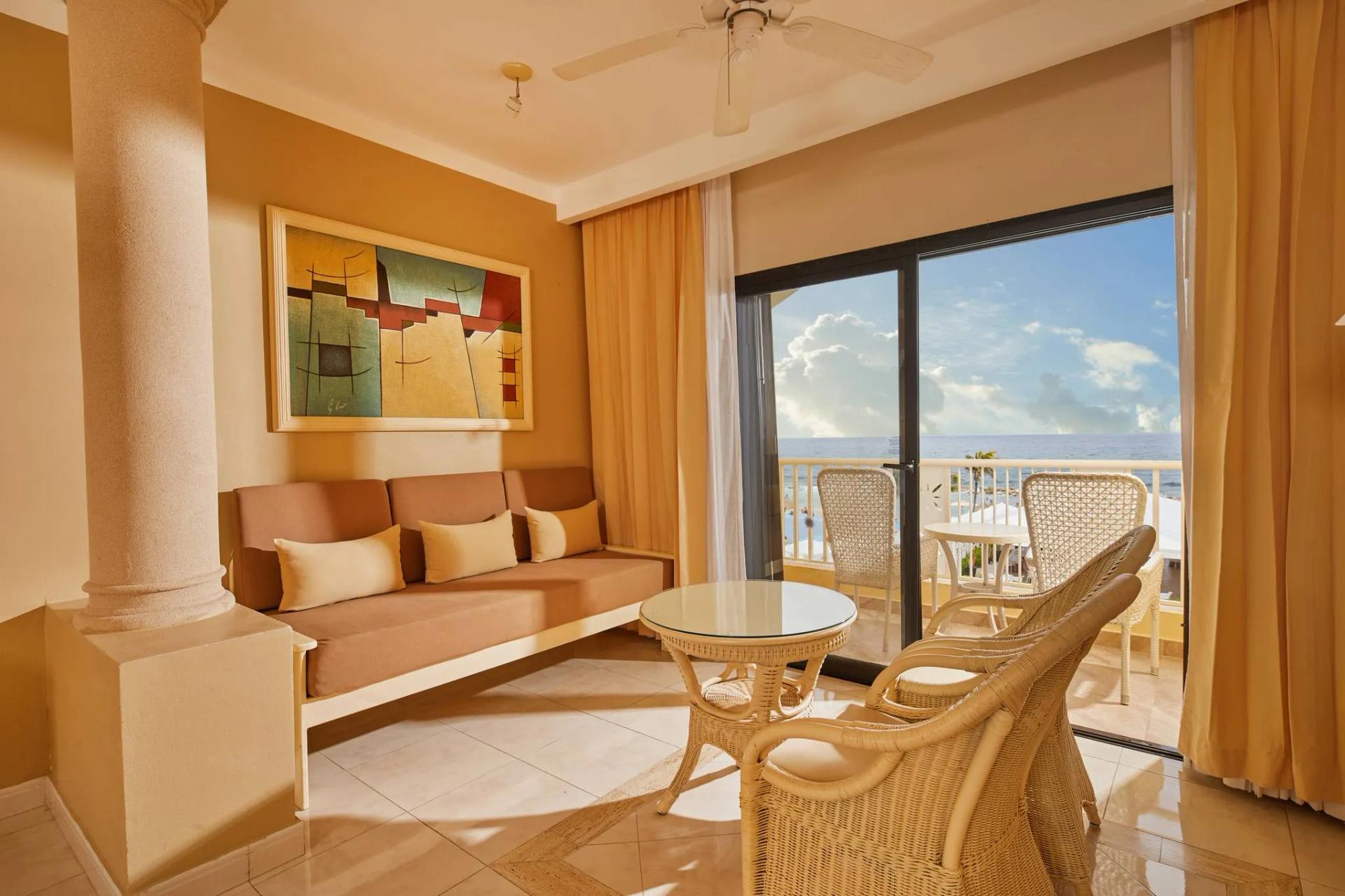 Lounging area at Luxury Bahia Principe Akumal with balcony views