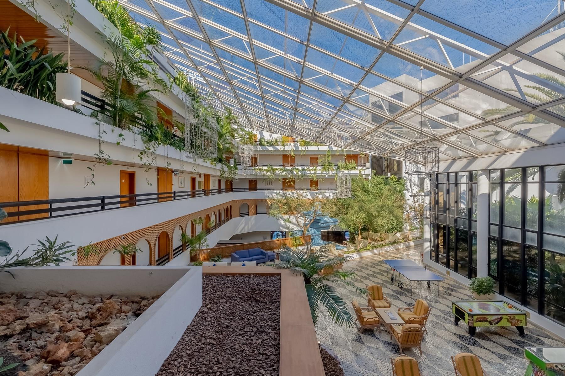 Indoor lounging area at Muthu Oura Praia Hotel with a sky light