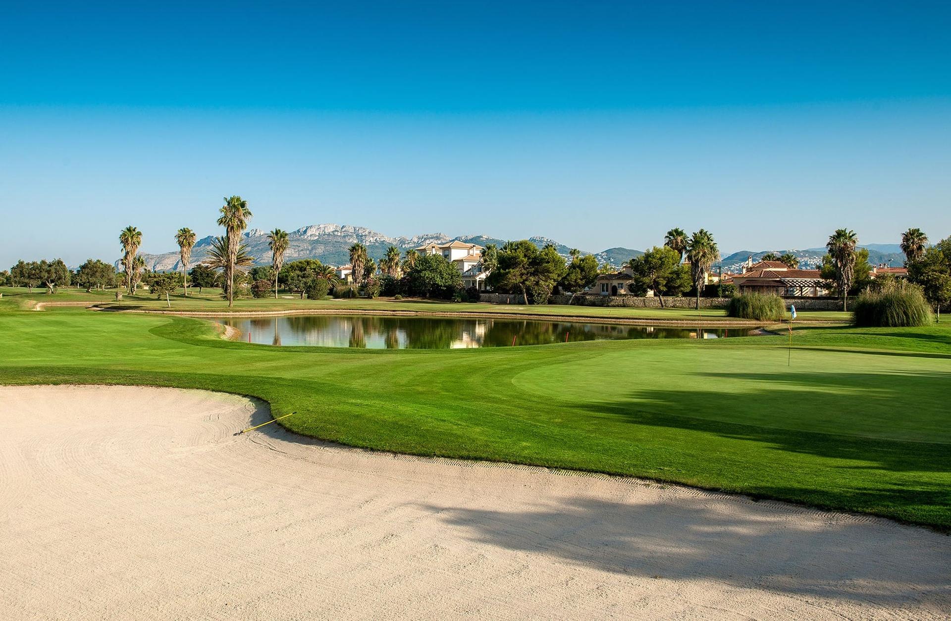 A large sand bunker next to a well maintained fairway at Oliva Nova Beach & Golf Hotel