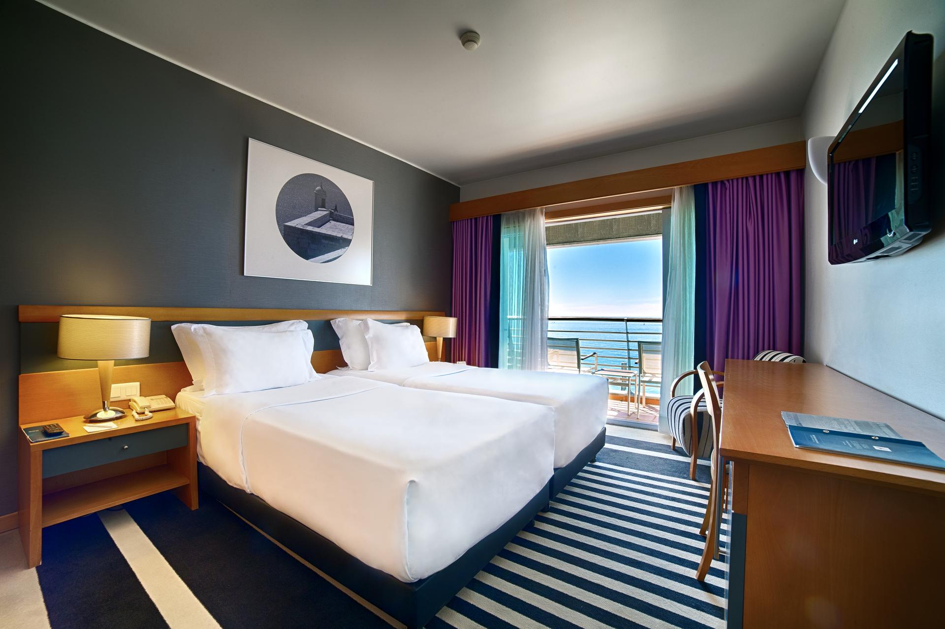 Twin bed suite at SANA Sesimbra Hotel