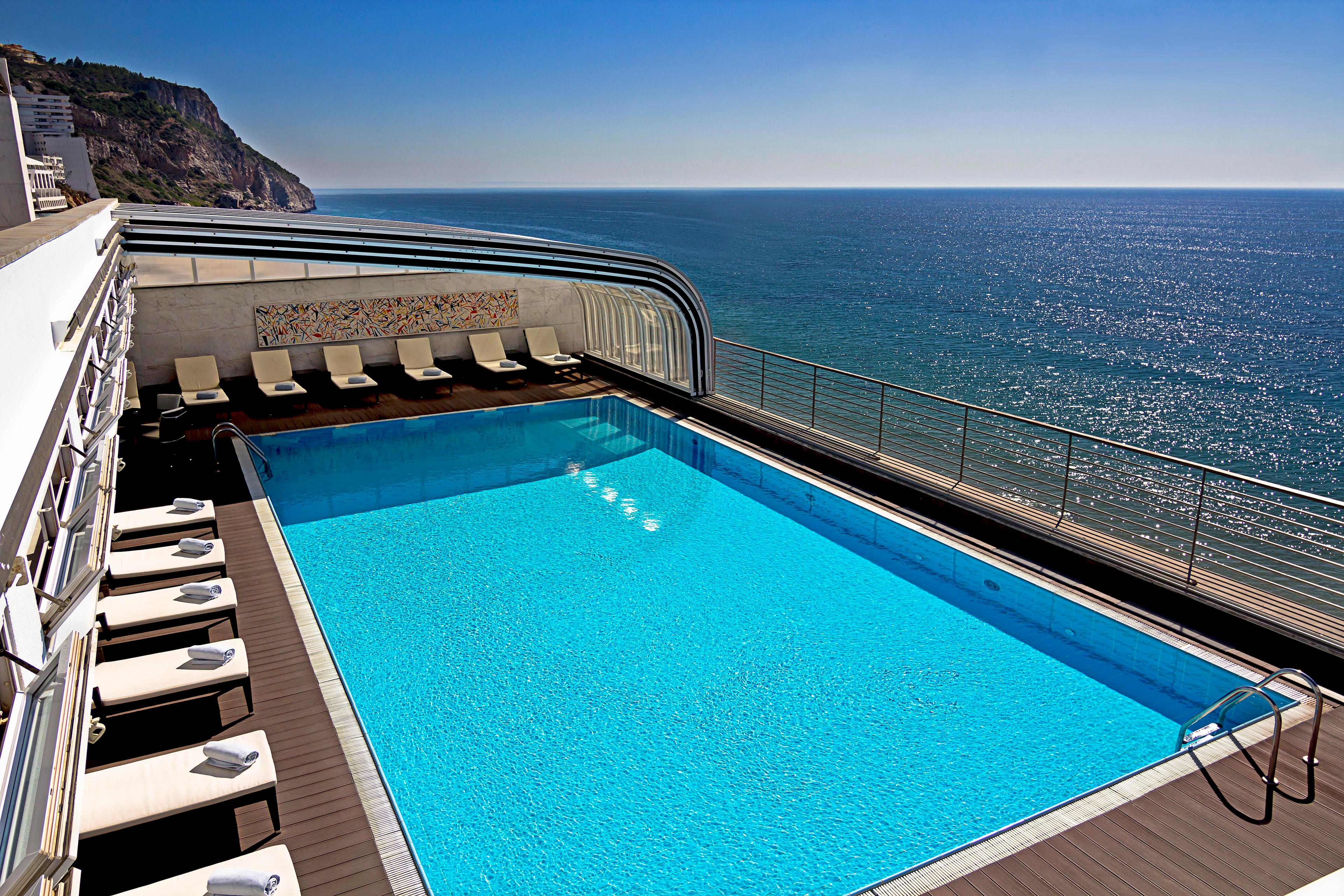 Overhead view of he rooftop swimming pool at SANA Sesimbra Hotel