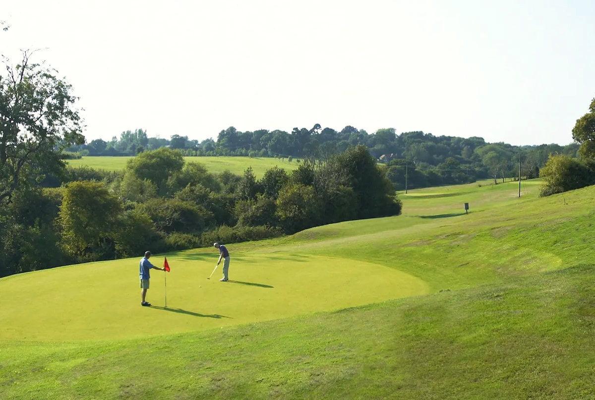 A well maintained fairway leading to a smooth grenn