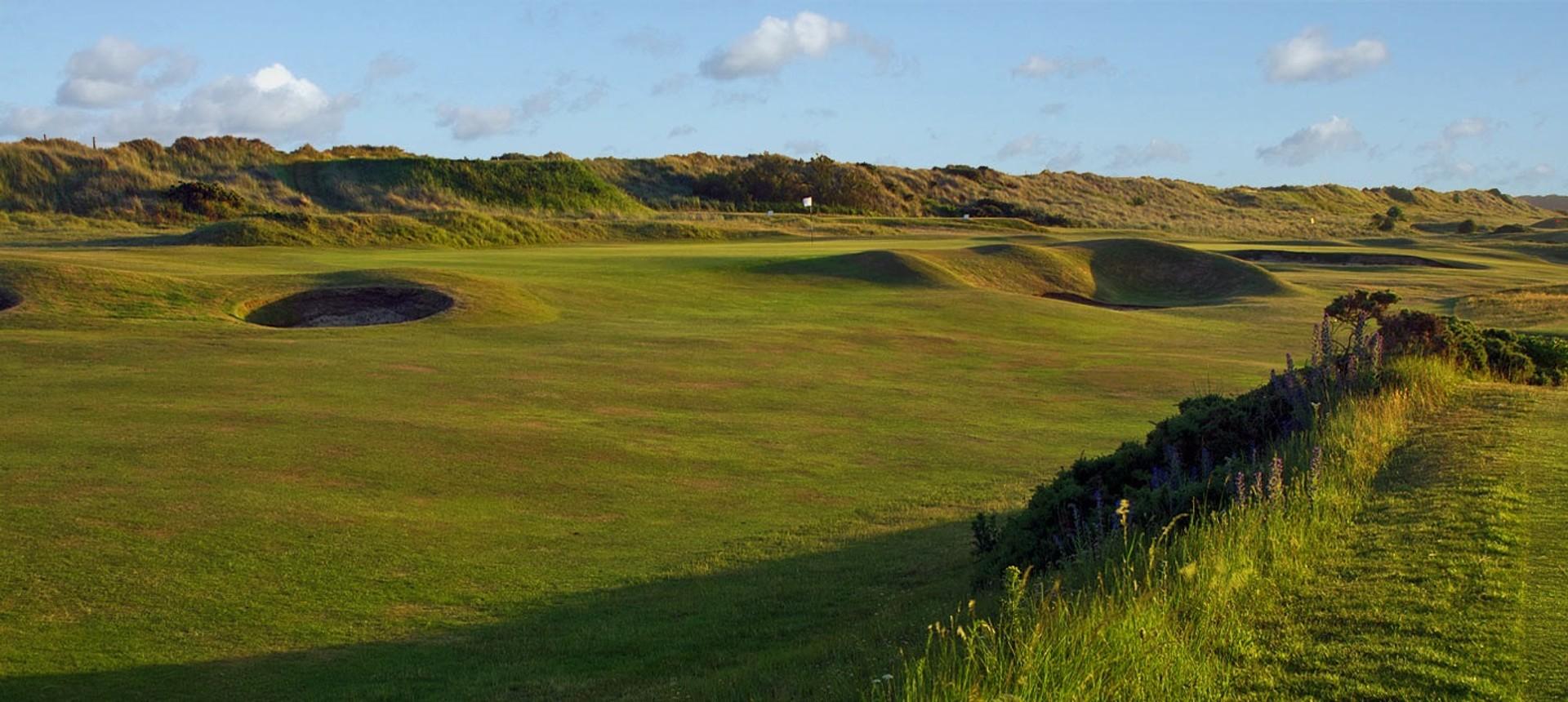 A well maintained fairway leading to a smooth green