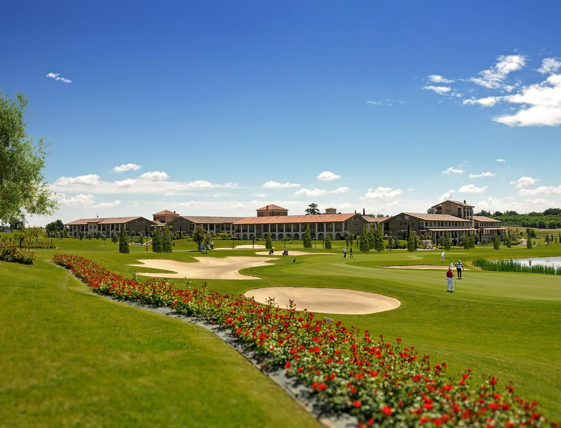 A well maintained fairway nestled with sand bunkers