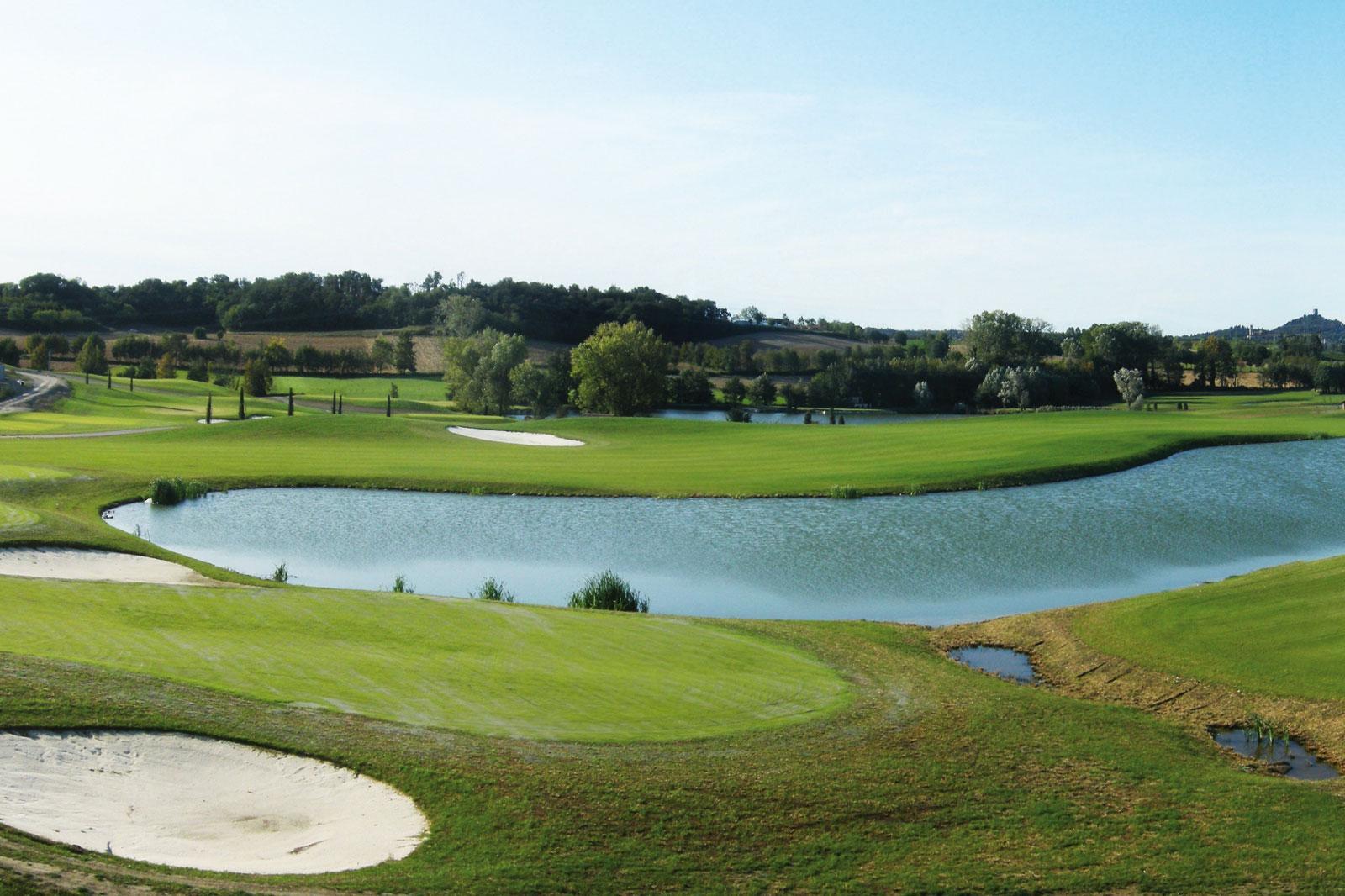 A well maintained fairway leading to a smooth green next to a sand bunker