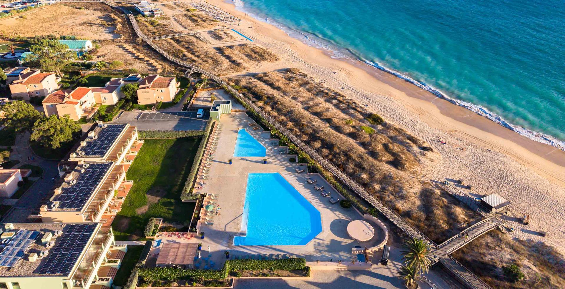 Overhead view of the beachfront pool and villas at Pestana Alvor Beach Villas