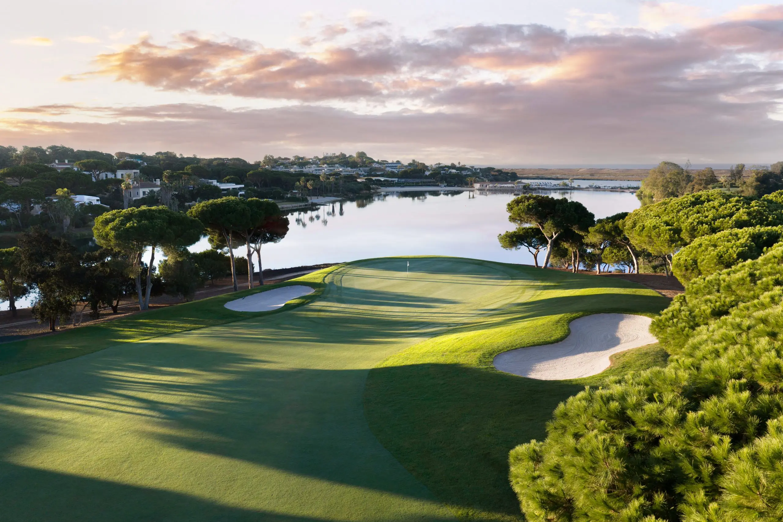 A well maintained fairway nestled with sand bunkers