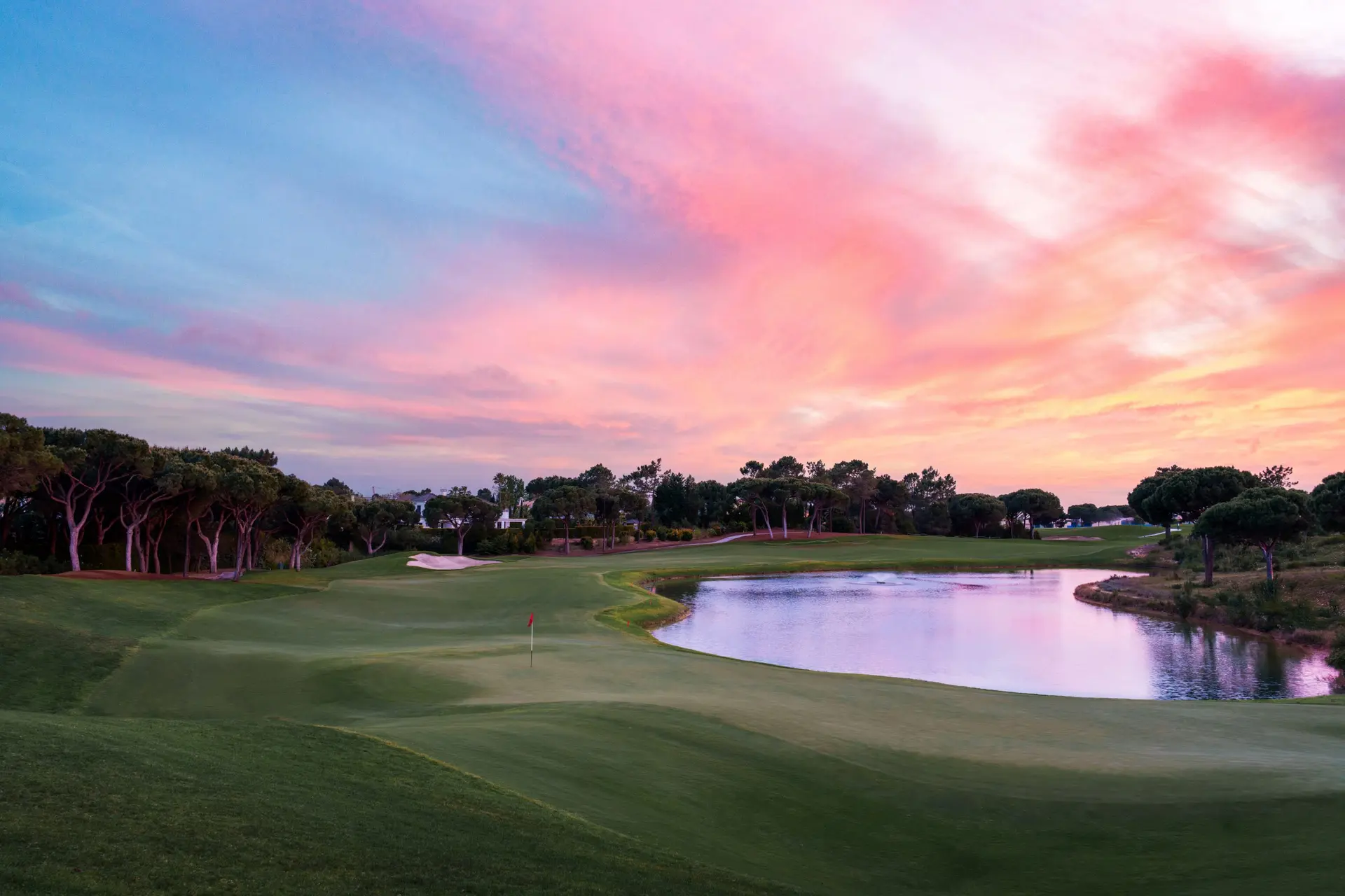 A well maintained fairway nestled with sand bunkers