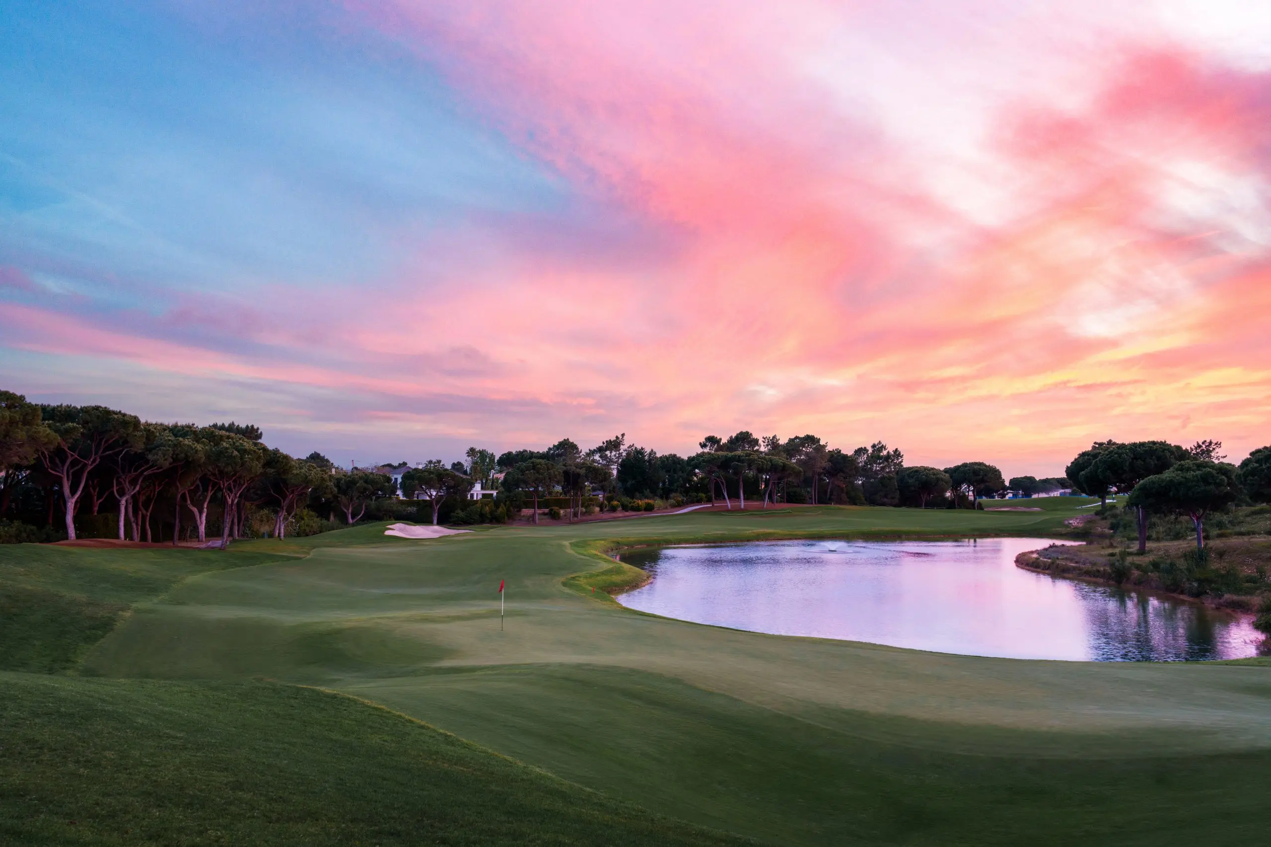 A well maintained fairway nestled with sand bunkers