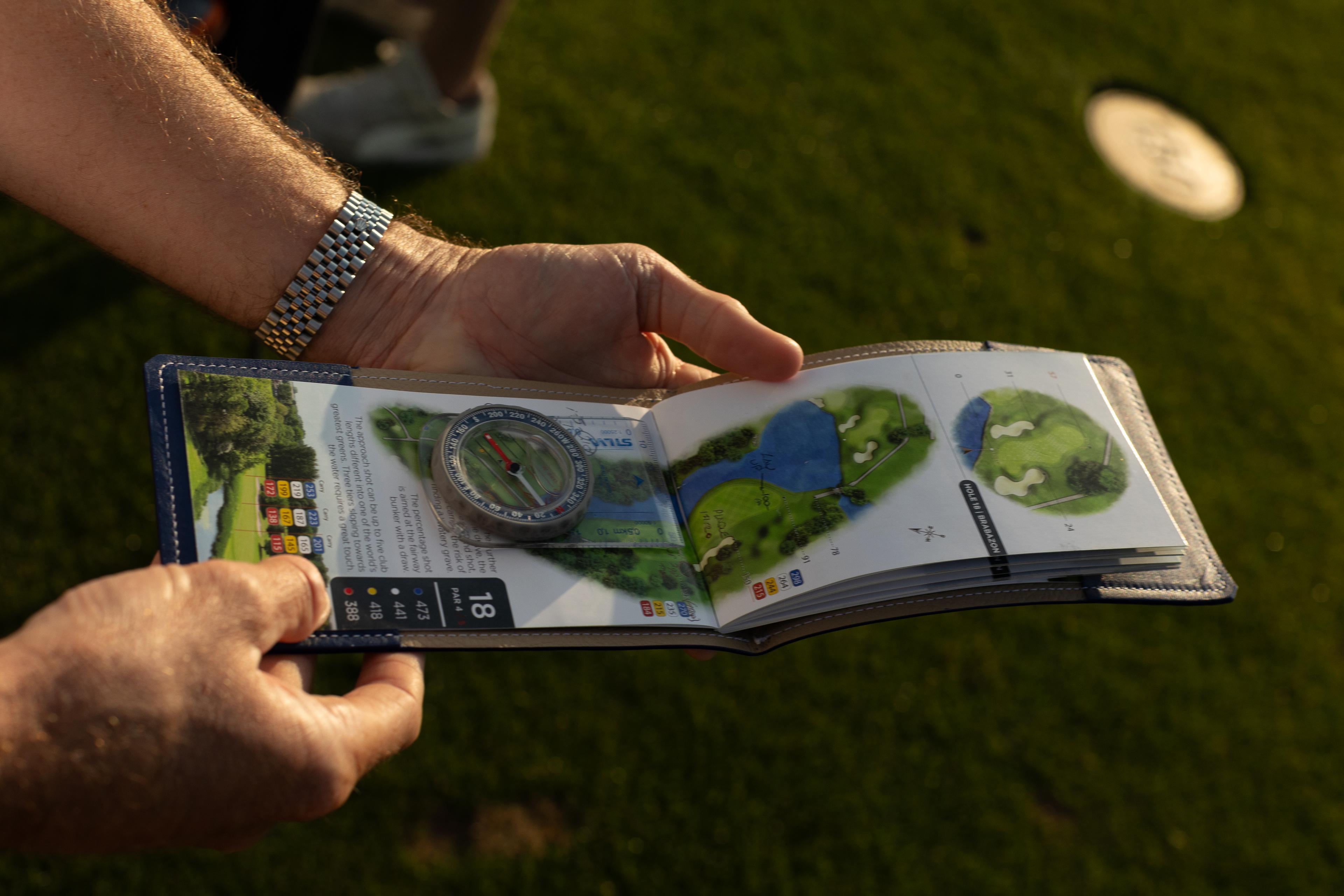 Caddy holding a course map.