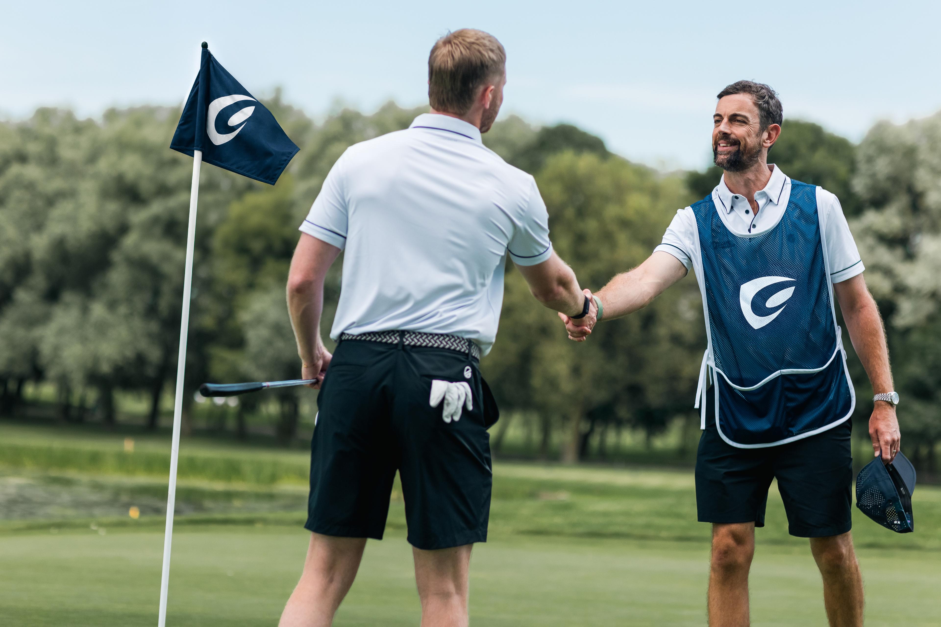 Golfer and Caddy shaking hands after a round of golf.
